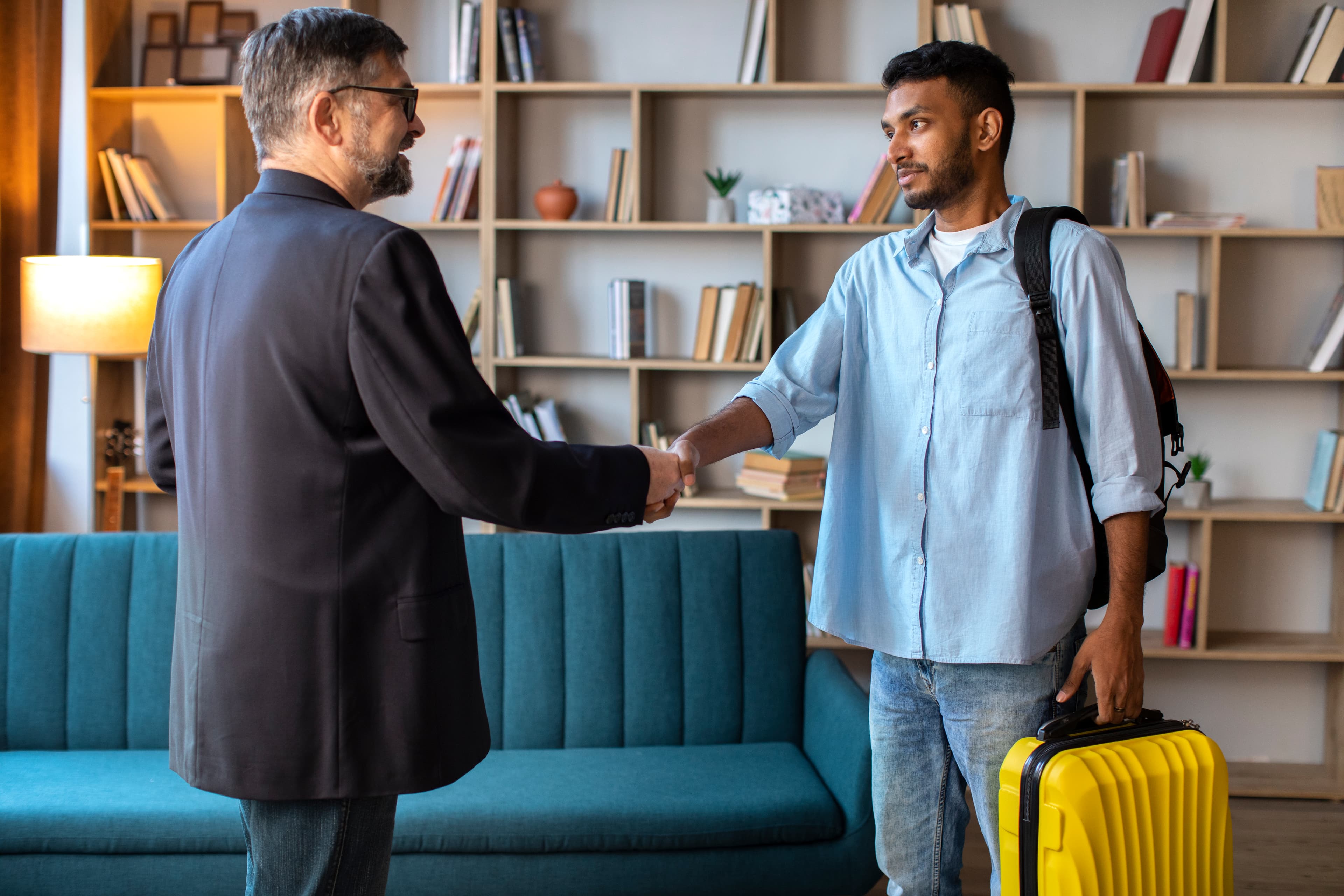 Shortlet host welcoming a guest at the apartment door