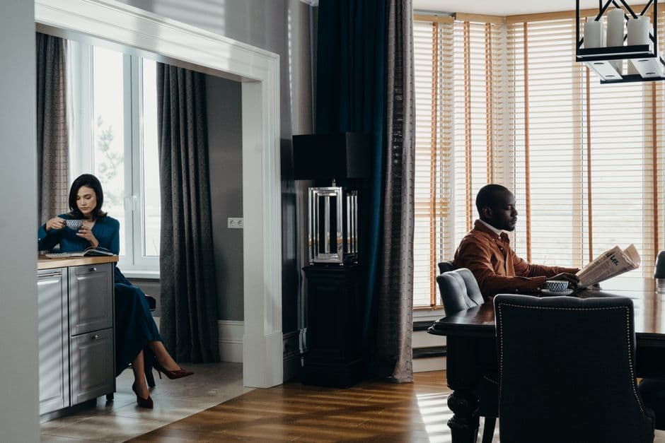 Elegant indoor scene featuring a couple enjoying a relaxed moment in a luxury apartment setting.
