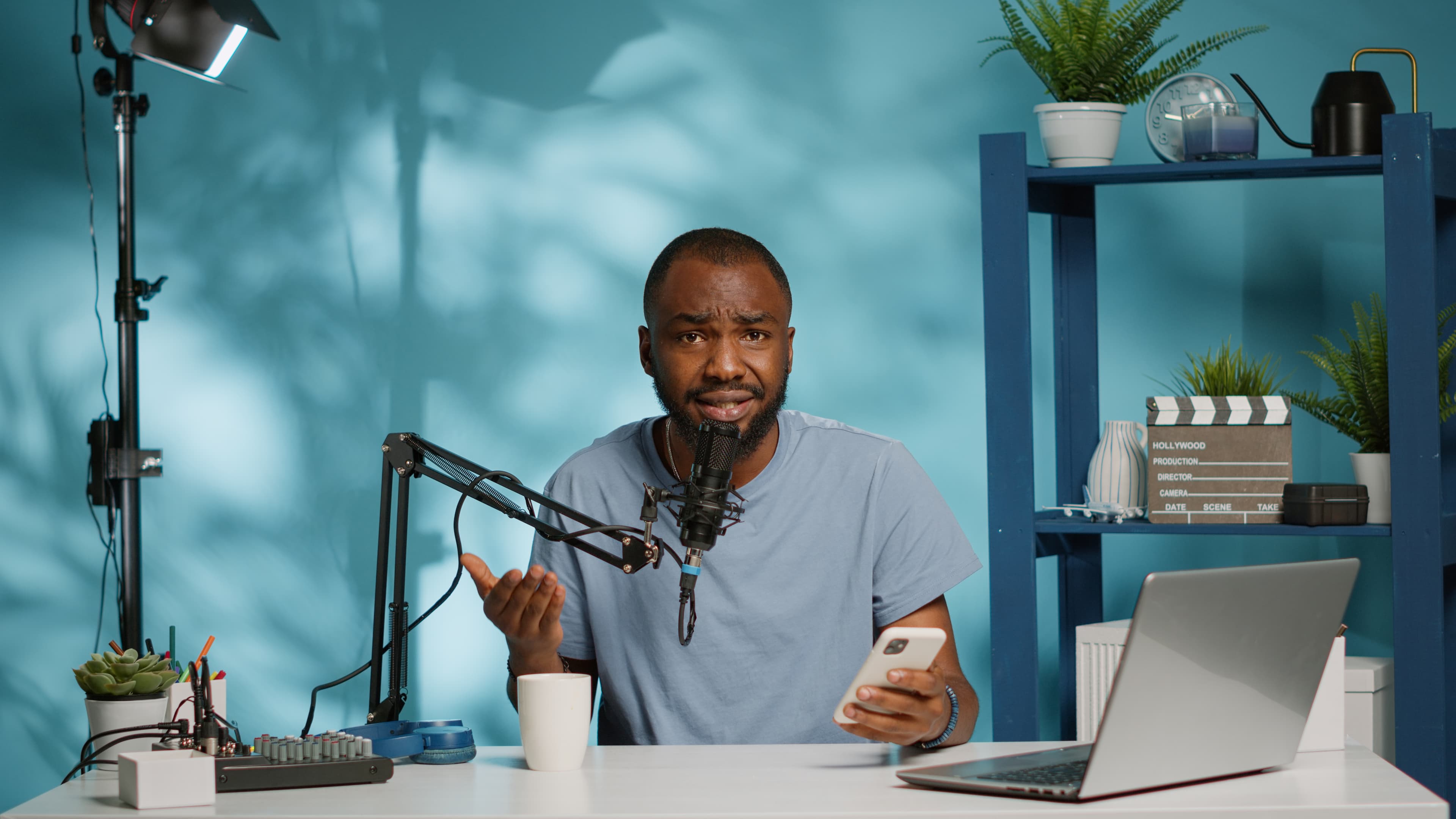 Podcaster recording an episode with a microphone in a furnished shortlet apartment in Lagos